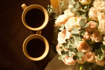 bouquet of flowers on the table with cups of coffee