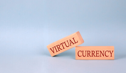 VIRTUAL CURRENCY text on the wooden block, blue background