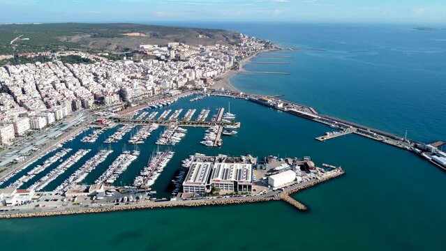 Aerial view of costal city Santa Pola. Situated in southeast of Spain Valencian Community is a famous travel destination. View of beautiful marina of Santa Pola. Boats docked. Drone truck right