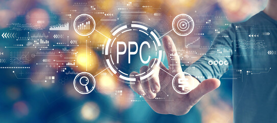 PPC - Pay per click concept with man on blurred city light background