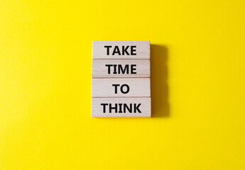 Take time to think symbol. Wooden blocks with words Take time to think. Beautiful yellow background. Business and Take time to think concept. Copy space.