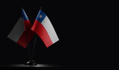 Small national flags of the Chile on a black background