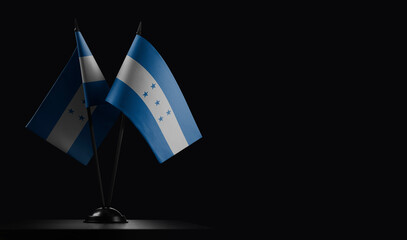 Small national flags of the Honduras on a black background