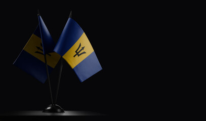 Small national flags of the Barbados on a black background