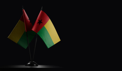 Small national flags of the Guinea Bissau on a black background