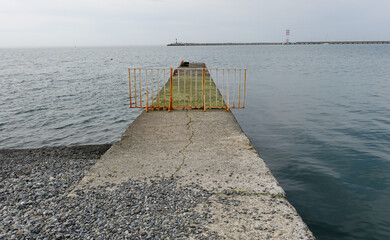 Landscape seashore, sea pier in clear weather.