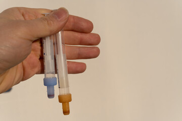Blood tubes in hand. Tubes of blood given to the patient before giving blood