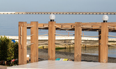 Landscape seashore, sea pier in clear weather.