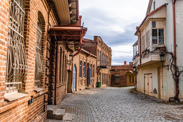 Cozy old street with stone pavement in the town of Signagi in Kakheti region, Georgia. Georgian touristic town of love.  Tile roof.