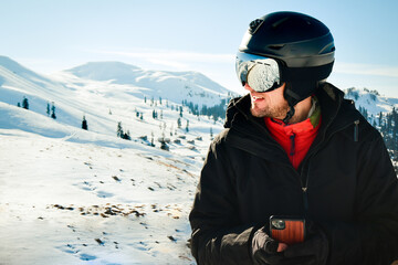 Fototapeta na wymiar Excited skier man in black jacket ski goggles mask text friends shot on mobile phone spend weekend winter in mountains isolated on purple background. People lifestyle hobby concept