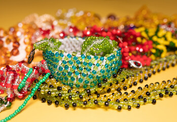 Beads, Jewelery, beads necklace on yellow background. 