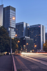 Fototapeta na wymiar Gebäude in Berlin Mitte zur blauen Stunde mit Lichtspuren auf der Straße und Beleuchtung 
