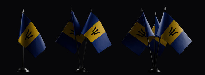 Small national flags of the Barbados on a black background