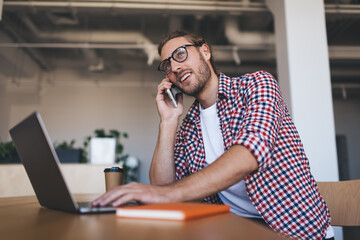 Millennial businessman working at desk in office