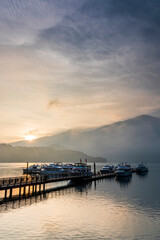 Obraz premium Sunrise view of yacht Marina in Sun Moon Lake, Nantou, Taiwan. it's a famous attraction in Taiwan.