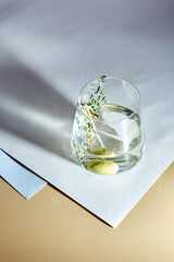 Cold alcoholic or non-alcoholic cocktail on pastel background. Hard light, deep shadow.