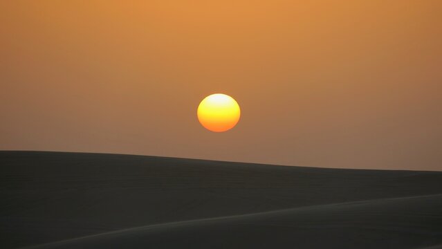 Sumset in desert dunes