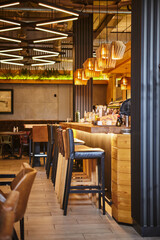 Interior of modern restaurant. Design in loft style, modern dining place and bar counter. Pub...