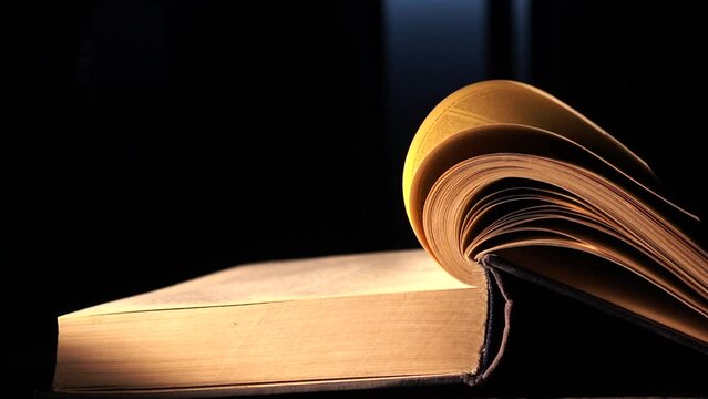 The Pages Of The Book Turn Over By Themselves. Slow-motion Video Of Turning The Page Of An Old Book