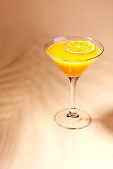 Cold alcoholic or non-alcoholic cocktail on pastel background. Hard light, deep shadow.