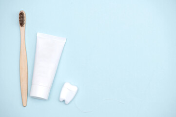 Oral hygien products on a light blue background with a place to insert text.