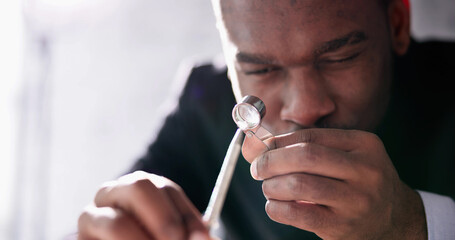 African American Jeweler Holding Diamond And