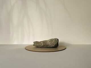Stone podium on beige background and palm shadow. Product promotion. Beauty cosmetic showcase.