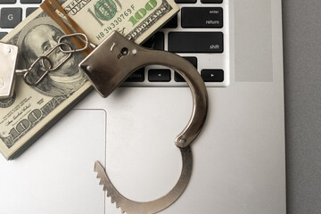 Handcuffs keyboard and dollars above