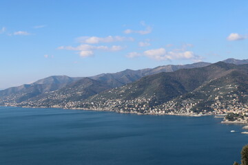 Camogli, Italy - January 28, 2023: An aerial view to the city of Camogli. Beautiful landscape from the ligurian sea with blue sky and mountains in the background. 