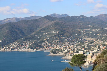 Fototapeta na wymiar Camogli, Italy - January 28, 2023: An aerial view to the city of Camogli. Beautiful landscape from the ligurian sea with blue sky and mountains in the background. 