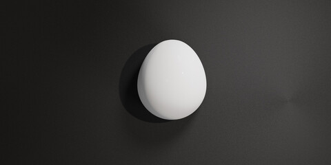 Single egg on black textured surface.
