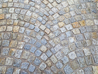 texture old stone blocks in gray in the city. road paved with granite stones