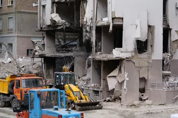 Tuinposter Workers clear rubble after bombing. Dwelling house damaged by russian missile © Harmony Video Pro