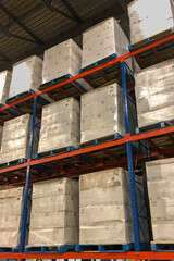 Fototapeta na wymiar Pallets of boxes of paper towels stacked in distribution center.