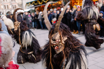 Procession of the Krampus Bavarian tradition in Germany. Costume parade fashing procession. Scary demon make-up with horns for halloween. Zombie parade. Terrible scary masks. Folk German folklore - obrazy, fototapety, plakaty