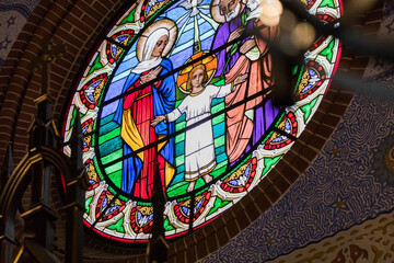 colorful stained glass with a litle Jesus in the church