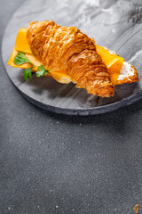 sandwich croissant with cheese fast food takeaway meal food snack on the table copy space food background rustic top view
