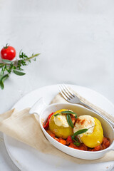 Baked potatoes in tomato sauce