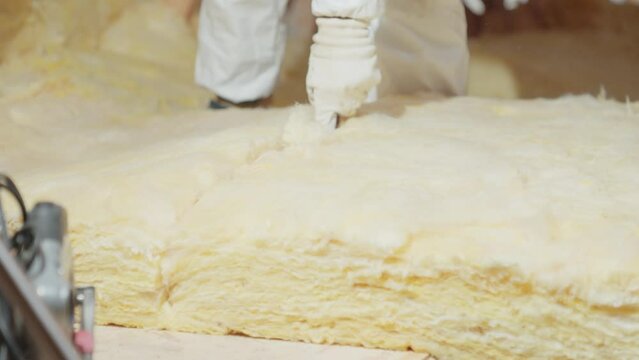 cutting glass wool when insulating the ceiling on the roof