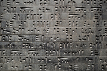 Cuneiform, street monument dedicated to ancient writing, relief stone slab