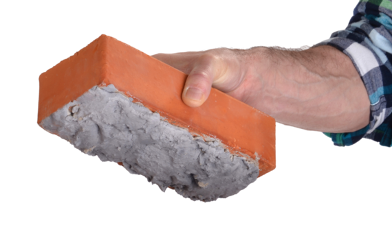 Hand holding construction brick isolated on layered png format background.