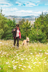 Happy woman with her dog outdoors.
