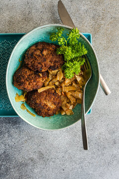 Overhead view of pork cutlets with stewed cabbage