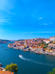 Fototapeta na wymiar Old town skyline in Porto, Portugal. Amazing cityscape with great town views and a beautiful sea.