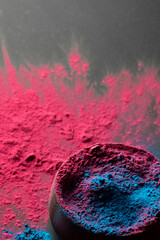 Close up of red and blue powder with round dish and copy space