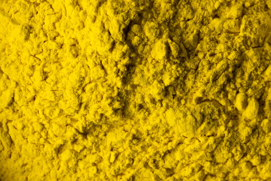 Close up of yellow powder background, with copy space