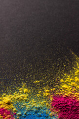 Close up of multi coloured powder and copy space on black background