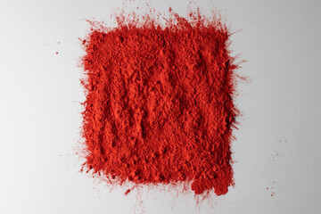 Close up of red powder with copy space on white background