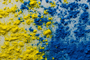Close up of yellow and blue coloured powder with copy space