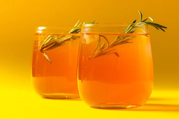 Poster Glasses with drinks and thyme over yellow background © vectorfusionart